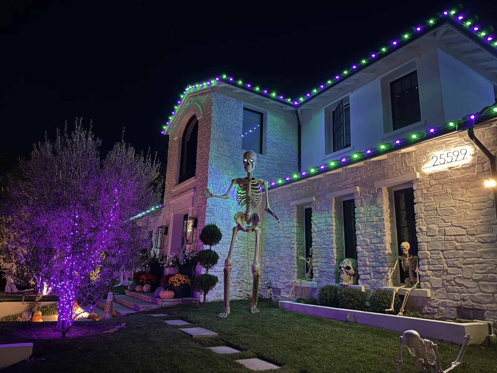 Halloween roofline lighting in orange with skeleton decorations